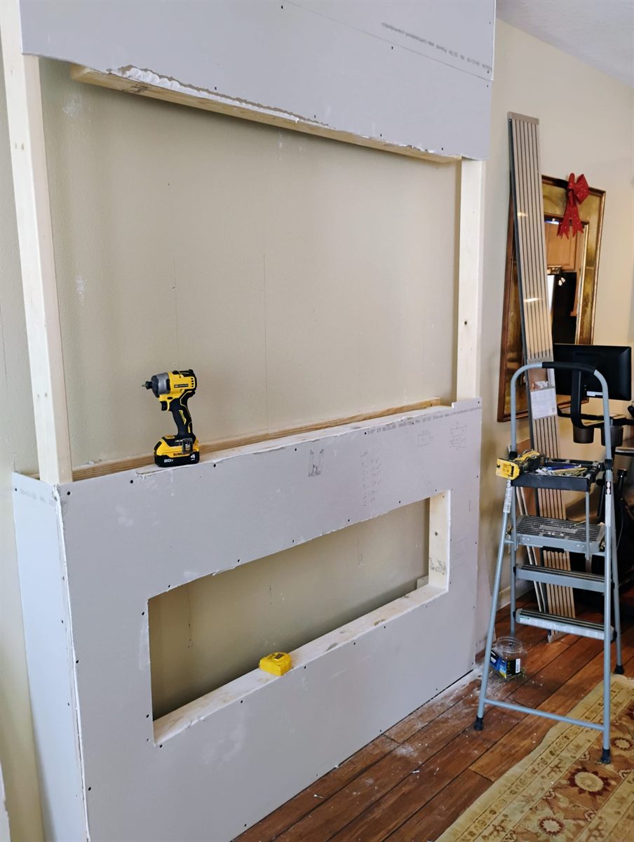 Living room wall framed out in drywall before the slat feature wall was built