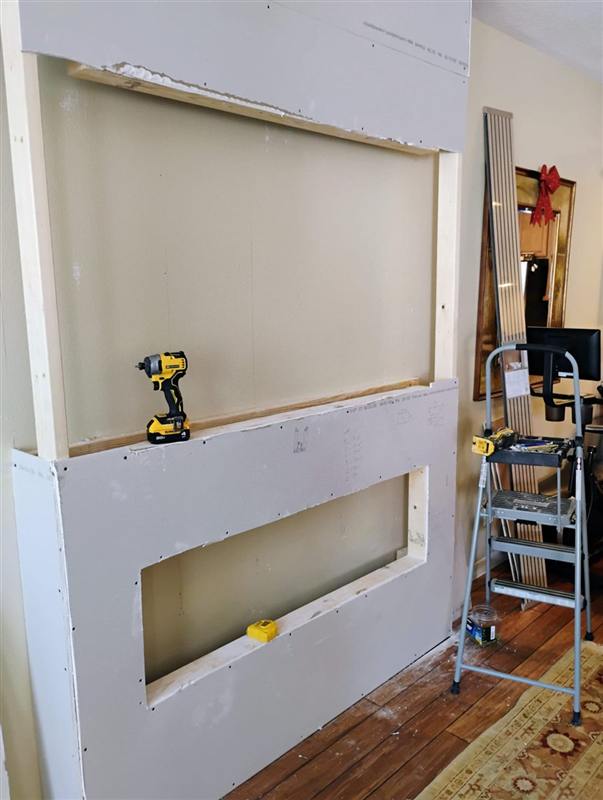 Living room wall framed out in drywall before the slat feature wall was built